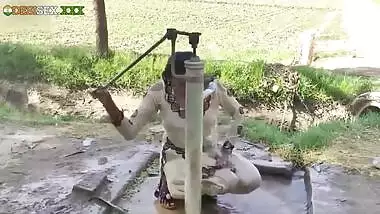Young village school girl taking a bath in a sari and caught on camera