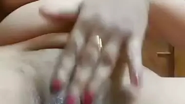 Chubby, young lady enjoys fingering her shaved pussy