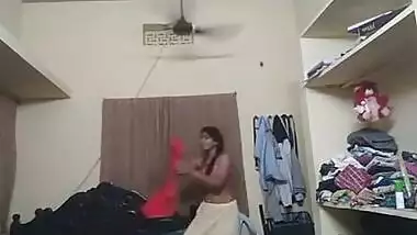 Indian girl wears pink bra and red top on camera in her bedroom
